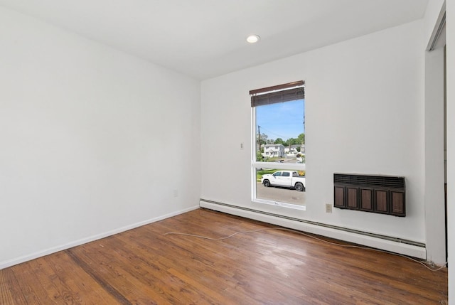 360 Robyn Pl, East Meadow, NY 11554 - empty room with a baseboard heating unit, wood finished floors, baseboards, and recessed lighting