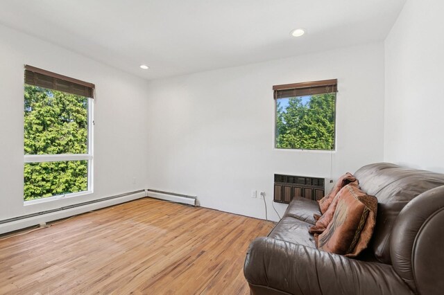 360 Robyn Pl, East Meadow, NY 11554 - sitting room with wood finished floors, recessed lighting, and a baseboard radiator