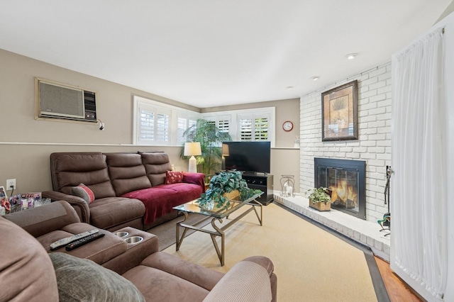 360 Robyn Pl, East Meadow, NY 11554 - living area with a wall mounted AC, a brick fireplace, and light wood-style floors