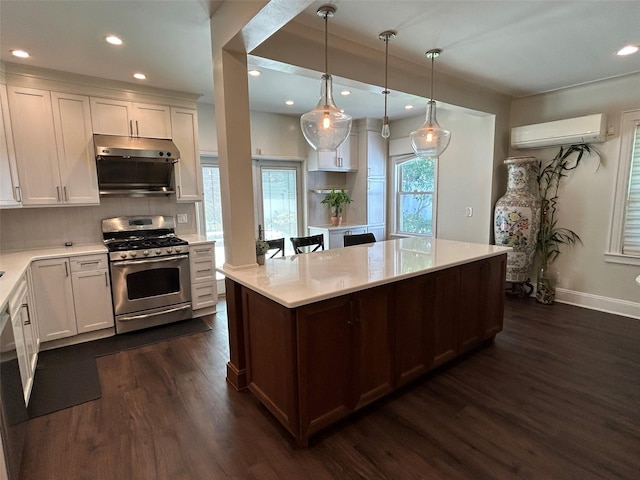 13-01 146th Pl, Whitestone, NY 11357 - kitchen featuring stainless steel range with gas stovetop, an AC wall unit, dark wood-style flooring, recessed lighting, and light countertops