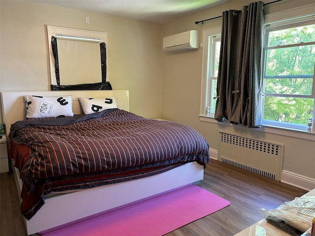 13-01 146th Pl, Whitestone, NY 11357 - bedroom with radiator heating unit, a wall mounted AC, multiple windows, and wood finished floors