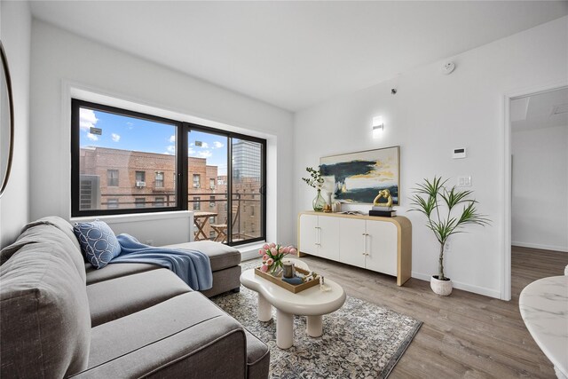 97-30 64th Ave Unit 3B, Rego Park, NY 11374 - living area featuring light wood finished floors and baseboards