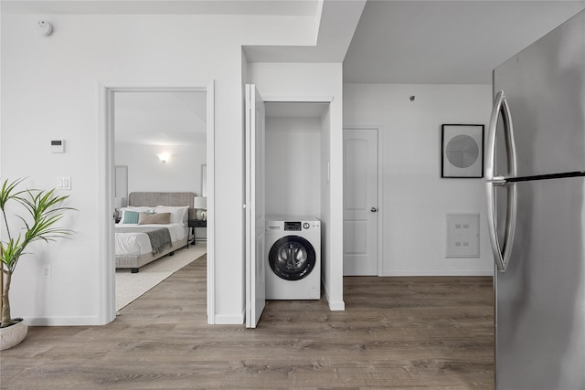 97-30 64th Ave Unit 3B, Rego Park, NY 11374 - washroom with washer / dryer, wood finished floors, and baseboards