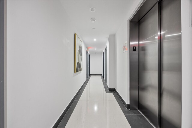 97-30 64th Ave Unit 3B, Rego Park, NY 11374 - hallway with elevator, baseboards, dark tile patterned flooring, and recessed lighting