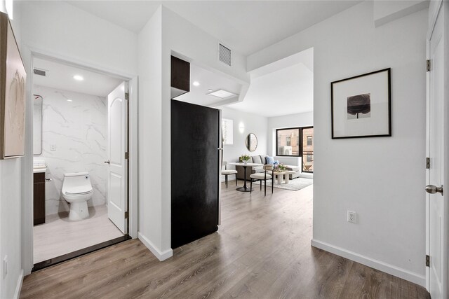97-30 64th Ave Unit 3C, Rego Park, NY 11374 - hall with wood finished floors, baseboards, and recessed lighting