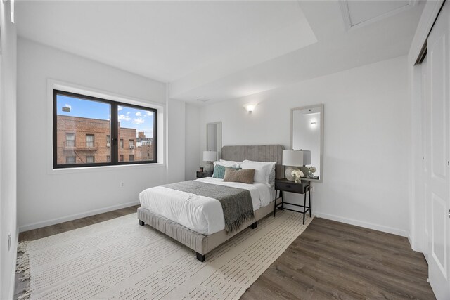 97-30 64th Ave Unit 7C, Rego Park, NY 11374 - bedroom featuring dark wood-style floors, baseboards, and a closet