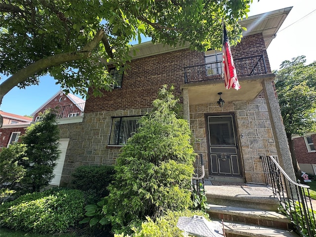 157-18 26th Ave, Flushing, NY 11354 - property entrance featuring stone siding and a garage