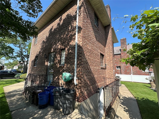 157-18 26th Ave, Flushing, NY 11354 - view of side of property with brick siding and a lawn