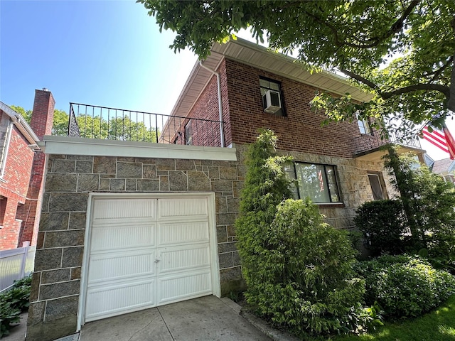 157-18 26th Ave, Flushing, NY 11354 - view of side of property featuring stone siding, an attached garage, and concrete driveway