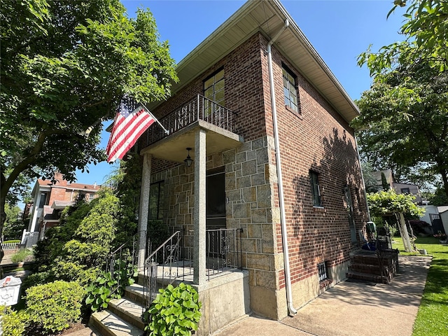 157-18 26th Ave, Flushing, NY 11354 - view of side of property with a balcony and brick siding