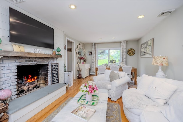 395 Main St, Northport, NY 11768 - living area with a fireplace, wood finished floors, and recessed lighting