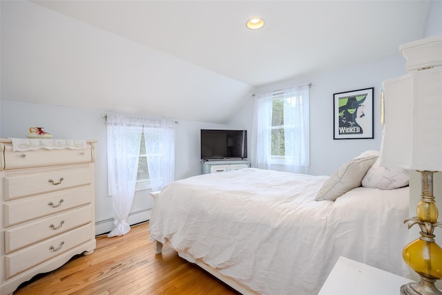 395 Main St, Northport, NY 11768 - bedroom featuring baseboard heating, lofted ceiling, light wood-style floors, and recessed lighting