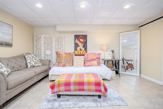 395 Main St, Northport, NY 11768 - tiled bedroom with recessed lighting, a barn door, and baseboards