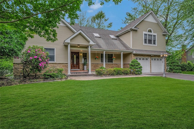 32 Robinhood Ln, East Setauket, NY 11733 - traditional-style house with an attached garage, asphalt driveway, a porch, a front lawn, and stone siding