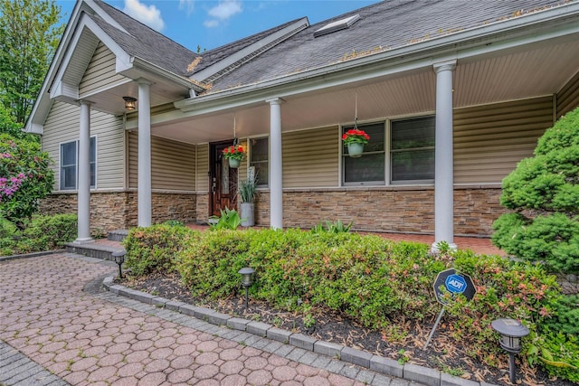 32 Robinhood Ln, East Setauket, NY 11733 - view of exterior entry featuring covered porch and stone siding