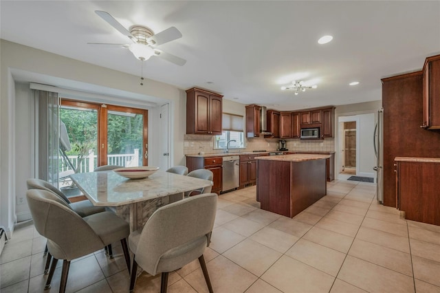 32 Robinhood Ln, East Setauket, NY 11733 - kitchen with appliances with stainless steel finishes, a kitchen island, backsplash, a ceiling fan, and light tile patterned flooring