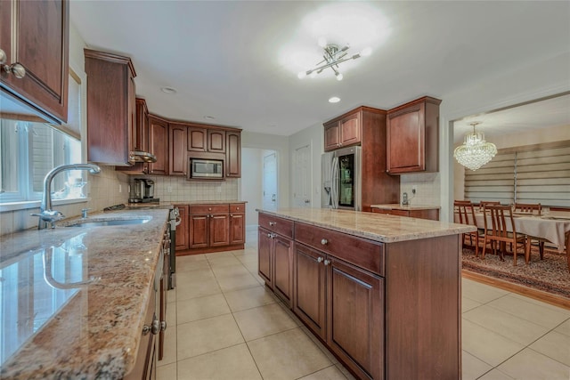 32 Robinhood Ln, East Setauket, NY 11733 - kitchen with appliances with stainless steel finishes, a sink, a chandelier, tasteful backsplash, and light tile patterned floors