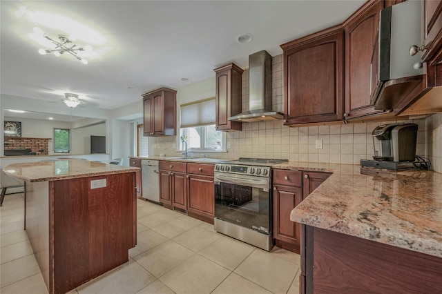 32 Robinhood Ln, East Setauket, NY 11733 - kitchen featuring stainless steel appliances, wall chimney range hood, decorative backsplash, light stone countertops, and a center island