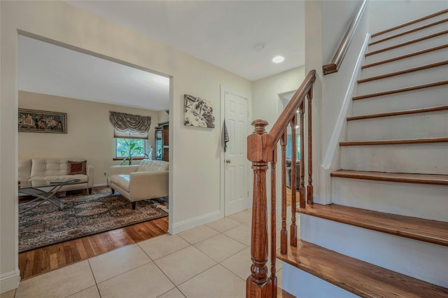 32 Robinhood Ln, East Setauket, NY 11733 - staircase featuring tile patterned floors, baseboards, and recessed lighting