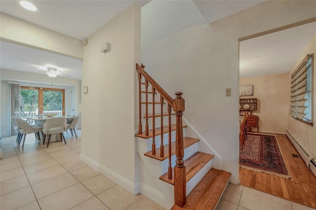 32 Robinhood Ln, East Setauket, NY 11733 - staircase with tile patterned floors, ceiling fan, baseboards, and a baseboard heating unit