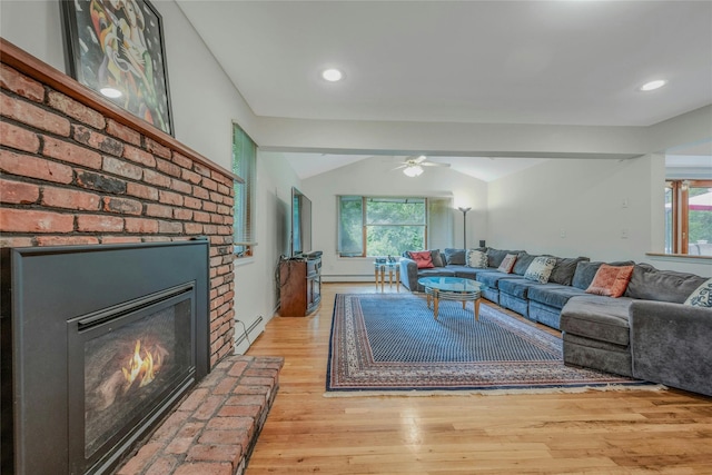 32 Robinhood Ln, East Setauket, NY 11733 - living area featuring a baseboard heating unit, a ceiling fan, lofted ceiling, light wood-style floors, and a fireplace