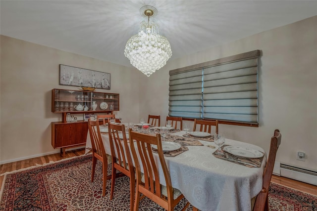 32 Robinhood Ln, East Setauket, NY 11733 - dining area with a chandelier, wood finished floors, a baseboard heating unit, and baseboards