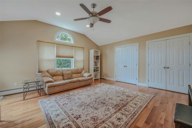 32 Robinhood Ln, East Setauket, NY 11733 - living area featuring baseboard heating, a ceiling fan, vaulted ceiling, light wood-type flooring, and baseboards