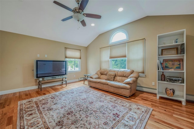 32 Robinhood Ln, East Setauket, NY 11733 - living area featuring a baseboard radiator, healthy amount of natural light, vaulted ceiling, a ceiling fan, and wood finished floors