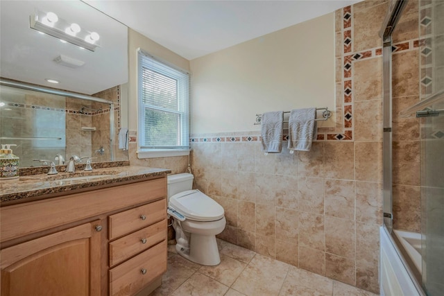 32 Robinhood Ln, East Setauket, NY 11733 - bathroom with tile walls, tile patterned floors, vanity, toilet, and wainscoting