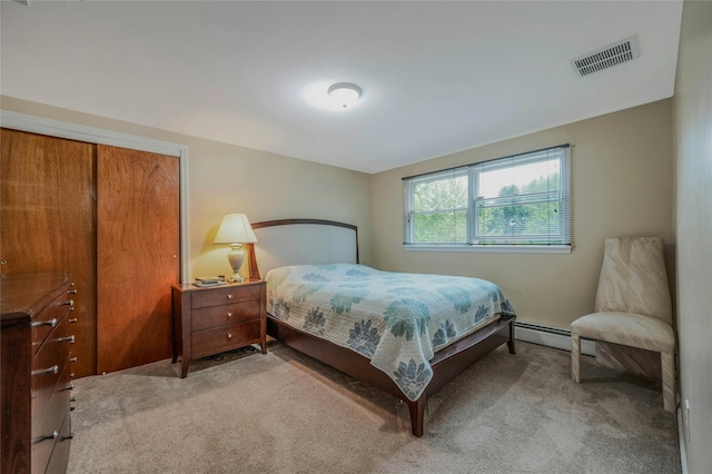 32 Robinhood Ln, East Setauket, NY 11733 - bedroom with light colored carpet and baseboard heating