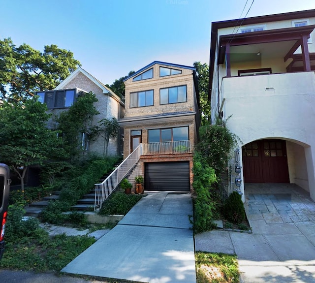 315 W 262nd St, Bronx, NY 10471 - view of front facade featuring stairway, stucco siding, driveway, and an attached garage
