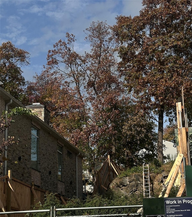 315 W 262nd St, Bronx, NY 10471 - view of property exterior with brick siding and a chimney
