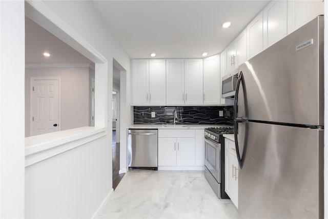 380 N Broadway Unit D4, Yonkers, NY 10701 - kitchen featuring appliances with stainless steel finishes, a sink, white cabinetry, light marble finish flooring, and recessed lighting