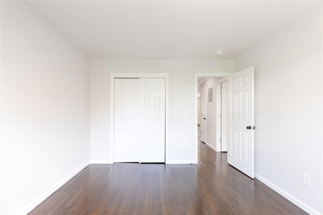 380 N Broadway Unit D4, Yonkers, NY 10701 - unfurnished bedroom with dark wood-style floors, baseboards, and a closet