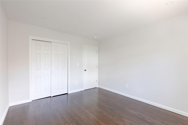 380 N Broadway Unit D4, Yonkers, NY 10701 - unfurnished bedroom with baseboards, dark wood-type flooring, and a closet
