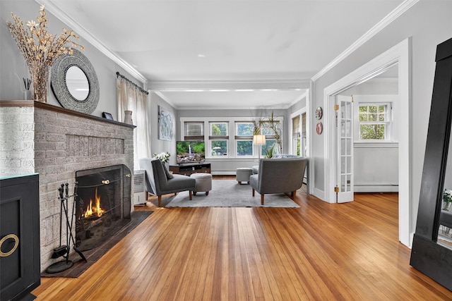 51 S Airmont Rd, Airmont, NY 10901 - living area featuring a brick fireplace, a baseboard radiator, baseboard heating, hardwood / wood-style flooring, and ornamental molding