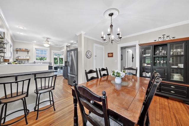 51 S Airmont Rd, Airmont, NY 10901 - dining space with a chandelier, ceiling fan, crown molding, and light wood-type flooring