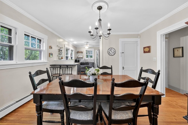 51 S Airmont Rd, Airmont, NY 10901 - dining space featuring baseboard heating, a chandelier, light wood-style floors, ornamental molding, and a ceiling fan