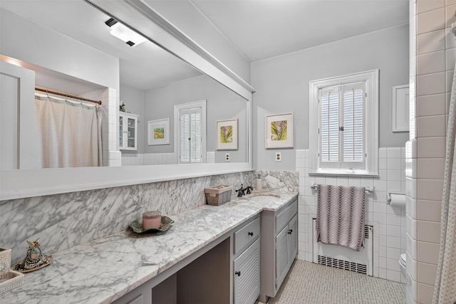 51 S Airmont Rd, Airmont, NY 10901 - full bathroom featuring tile walls, tile patterned floors, double vanity, wainscoting, and curtained shower