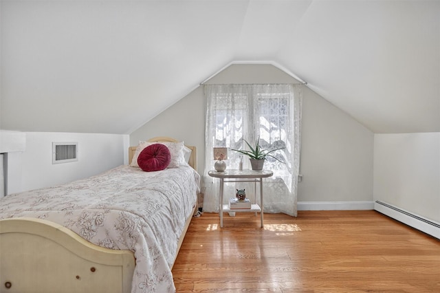 51 S Airmont Rd, Airmont, NY 10901 - bedroom with wood finished floors, vaulted ceiling, and baseboard heating