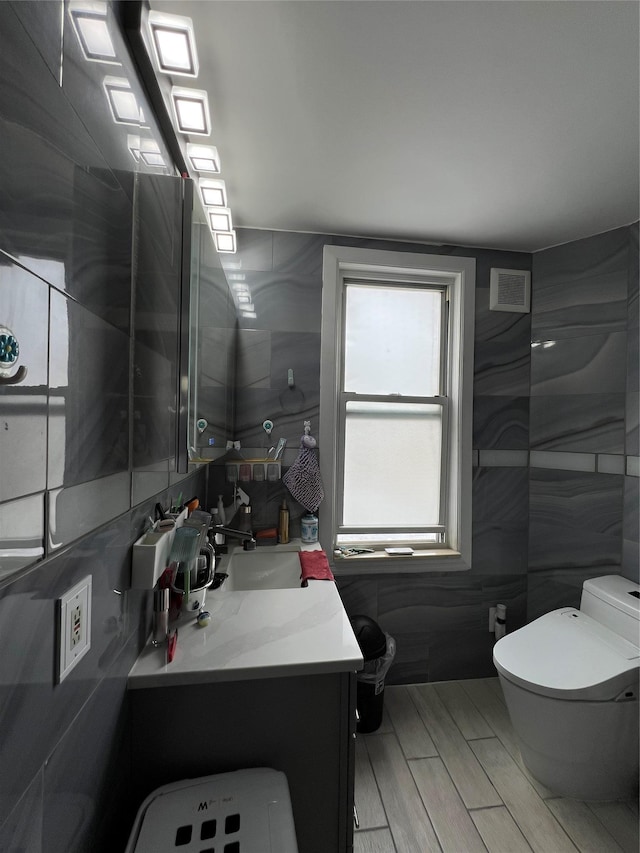 8624 79th St, Woodhaven, NY 11421 - bathroom featuring toilet, vanity, and tile walls