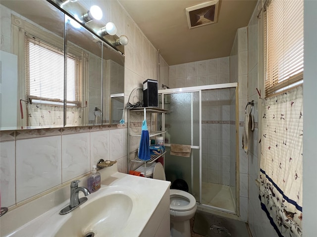8624 79th St, Woodhaven, NY 11421 - bathroom with tile walls, a stall shower, toilet, and vanity