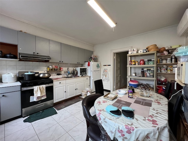 8624 79th St, Woodhaven, NY 11421 - kitchen with white appliances, under cabinet range hood, gray cabinets, and ornamental molding