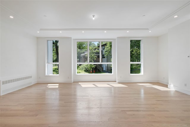 40 Singer Ave Unit 201, Spring Valley, NY 10977 - empty room featuring radiator heating unit, light wood finished floors, and recessed lighting