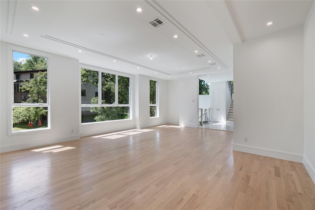 40 Singer Ave Unit 201, Spring Valley, NY 10977 - unfurnished living room featuring light wood finished floors, recessed lighting, and stairs