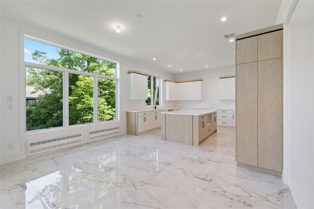 40 Singer Ave Unit 201, Spring Valley, NY 10977 - kitchen featuring modern cabinets, a kitchen island, light brown cabinetry, recessed lighting, and radiator