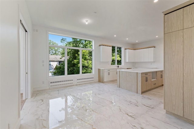 40 Singer Ave Unit 201, Spring Valley, NY 10977 - kitchen featuring modern cabinets, healthy amount of natural light, light marble finish floors, and recessed lighting