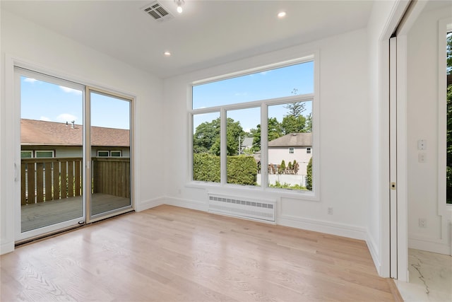 40 Singer Ave Unit 201, Spring Valley, NY 10977 - empty room featuring radiator heating unit, recessed lighting, and light wood finished floors