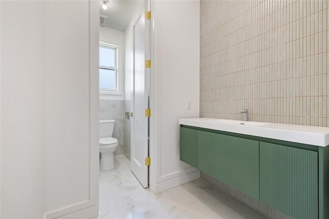40 Singer Ave Unit 201, Spring Valley, NY 10977 - bathroom featuring marble look tiles, vanity, and tile walls