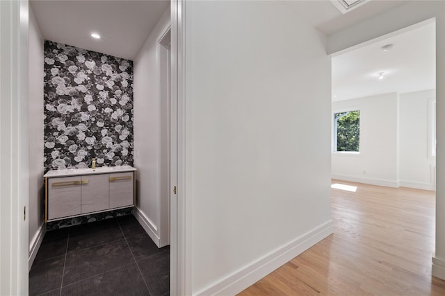 40 Singer Ave Unit 201, Spring Valley, NY 10977 - bathroom with vanity, an accent wall, wallpapered walls, and wood finished floors